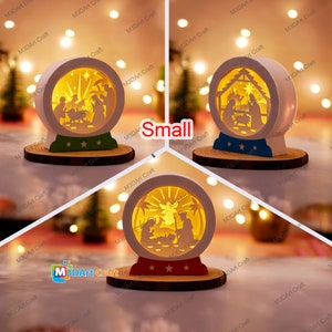 May include: Three white wooden Christmas snow globes with a light inside. Each globe features a different scene of the nativity. The globes are on a wooden base with a red, green, or blue trim.
