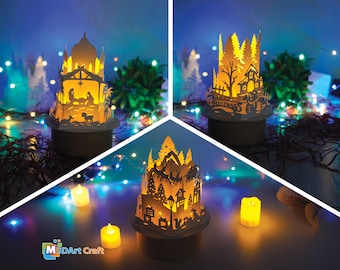 Könnte beinhalten: Drei leuchtende Weihnachtsdekorationen aus Papier mit warmem Schein. Die erste zeigt eine Weihnachtskrippe, die zweite ein Winterdorf und die dritte einen verschneiten Wald mit einem Rentier und einem Schlitten.