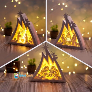May include: A wooden Christmas nativity scene with a light inside. The scene depicts the holy family, a star, and animals. The scene is in a triangular shape and is lit from the inside.