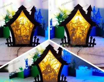 May include: Three black wooden Halloween light-up houses with intricate cut-out designs. The houses feature a graveyard scene, a spooky tree, and a monster. The houses are illuminated from within, casting a warm glow.