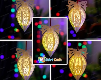 May include: Set of five white paper Christmas ornaments with intricate cut-out designs. The ornaments are illuminated from within, casting a warm glow. Each ornament features a different design, including snowflakes, a Christmas tree, and a snowman.