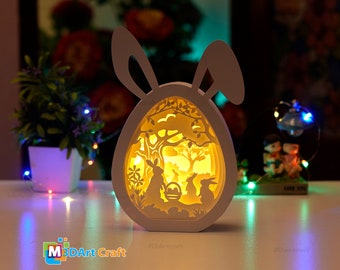 Famille de lapins Easter Eggs Shadow Box SVG pour les projets Cricut - Lanterne en papier de Pâques - Boîte lumineuse d’œufs de lapin de Pâques - Papier superposé 3D SVG