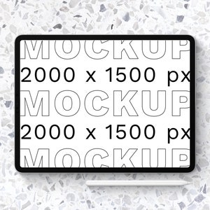 Puede incluir: Una tableta negra con una pantalla blanca que muestra el texto "MOCKUP 2000 x 1500 px" repetido tres veces. Un lápiz blanco está acostado junto a la tableta sobre una superficie blanca y gris moteada.