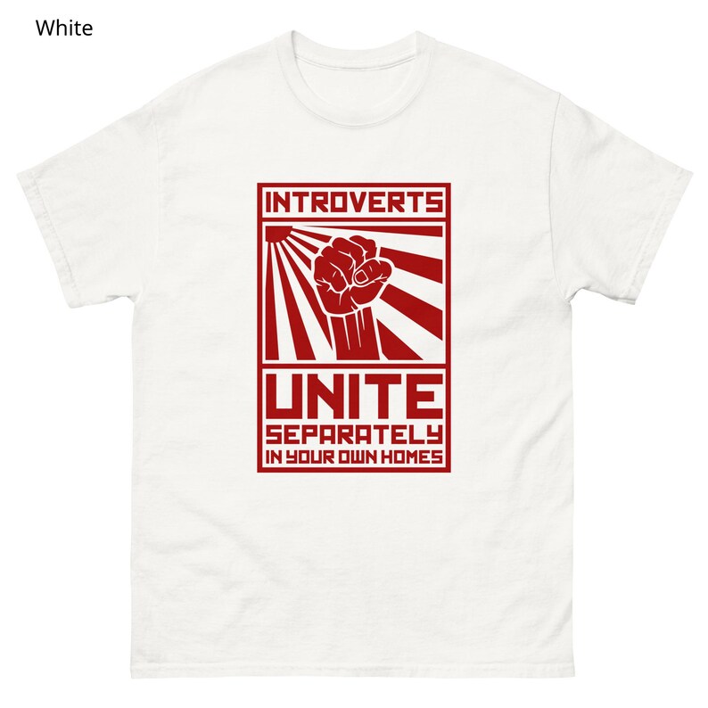 May include: White t-shirt with a red graphic. The graphic features the word "INTROVERTS" above a clenched fist, sun rays, and the word "UNITE" with the phrase "SEPARATELY IN YOUR OWN HOMES" below.