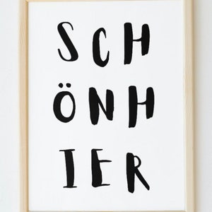 Könnte beinhalten: Ein gerahmter Druck mit dem Wort "SCHÖNHER" in schwarzer Schrift auf weißem Hintergrund.