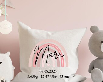 May include: A white square pillow with a pink rainbow design and the name "Mara" in cursive script. Below the rainbow are the numbers "09.08.2025", "3.650g", "12:47 Uhr", and "53 cm".