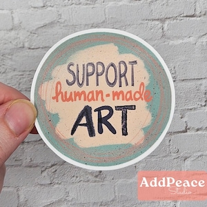 Support human-made art is hand-written over a scribbled background