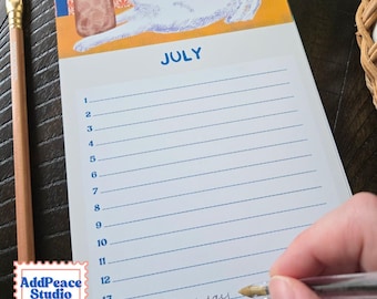 May include: A vertical July calendar notepad featuring a blue header and a top illustration of a white cat stretching next to a glass of iced tea. The page includes numbered lines from 1 to 14, with the text Mom's Birthday written on line 14.