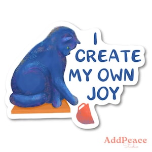 May include: A sticker featuring a blue cat sitting on a small orange surface, with the text "I CREATE MY OWN JOY." A small red mug is next to the cat. The sticker has a white border and the words "AddPeace Studio" at the bottom.