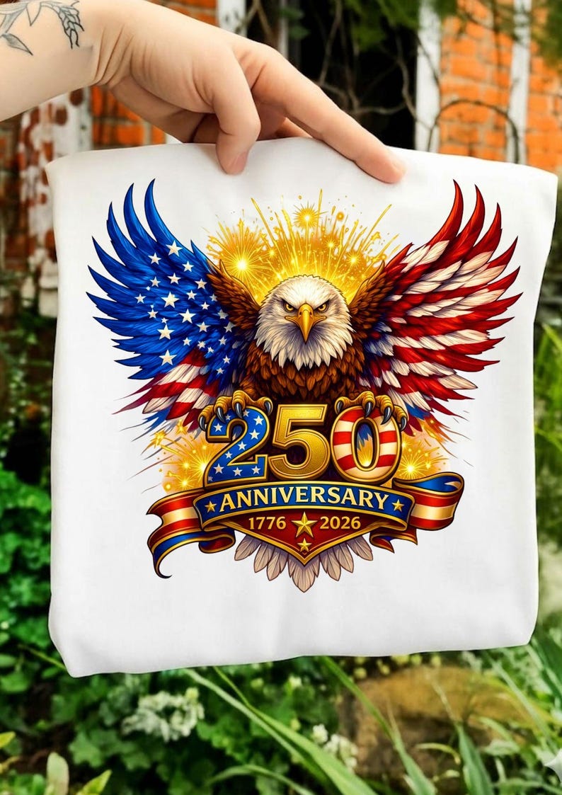 May include: White tote bag with a patriotic design. It features an eagle with wings in red, white, and blue, resembling the American flag. The text reads "250 Anniversary 1776-2026".