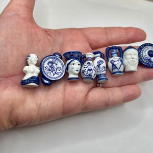 May include: A set of three ceramic mugs with a speckled, matte finish. The mugs are in shades of cream, light brown, and dark brown. Each mug has a simple, minimalist design, perfect for coffee or tea.