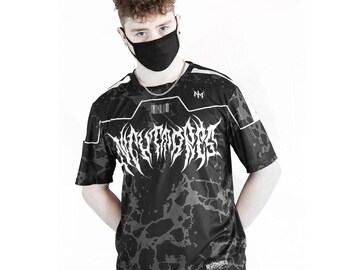 Puede incluir: Camiseta de manga corta con estampado negro y gris con la palabra "NIGHTMARES" en fuente gótica blanca. La camiseta tiene ribetes blancos y las letras "NM" en el hombro superior derecho. Se usa una mascarilla negra.