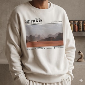 Könnte beinhalten: Ein Set aus drei Keramikbechern mit gesprenkelter, matter Oberfläche. Die Becher sind in Creme-, Hellgrau- und Dunkelgrautönen gehalten. Jeder Becher hat ein schlichtes, minimalistisches Design.