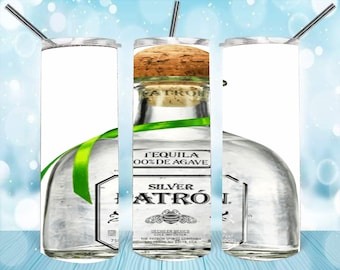 May include: A stainless steel tumbler with a design of a clear glass bottle of Patron Silver Tequila. The bottle has a green ribbon around the neck and a cork top. The label reads "Tequila 100% de Agave Silver Patron".