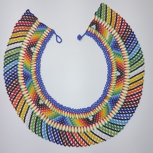 May include: A colourful beaded necklace with a geometric pattern in shades of red, orange, yellow, green, blue, black and white.