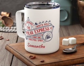 May include: White travel mug with a blue and red design that says "All Aboard! The Polar Express North Pole. Admit One Christmas Spirit." The mug has a black handle and the name Samantha is printed on the bottom.