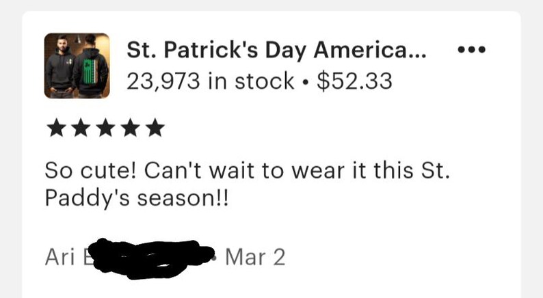 May include: A black hoodie with a green shamrock and the text "St. Patrick's Day America..." printed on the back. The hoodie is being worn by a person in the image. The image also includes a five-star rating and the text "So cute! Can't wait to wear it this St. Paddy's season!!"  The text "Ari E... Mar 2" is also included in the image.