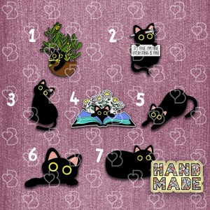 May include: Set of seven black cat enamel pins. The pins feature different poses and designs, including a cat in a plant pot, a cat reading a book, and a cat with a sign that says "It's fine, I'm fine, everything is fine".