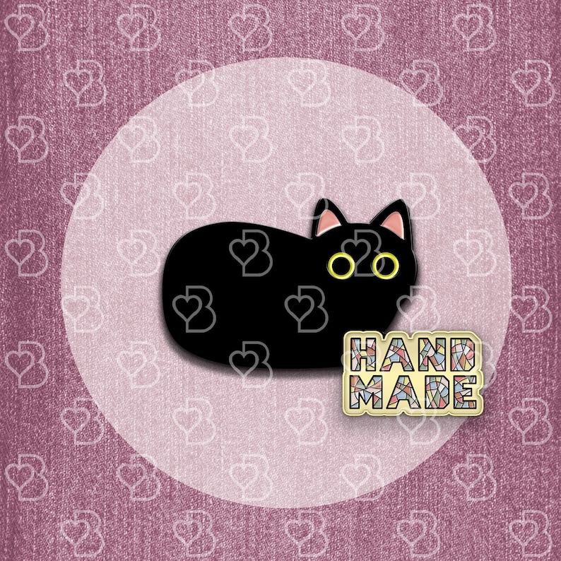May include: Black cat pin with yellow eyes, lying down on a white background. The pin has a mosaic-style "HAND MADE" label.
