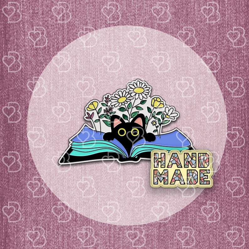 May include: Black cat peeking out from an open book with colorful flowers. The book is blue and green with a white background. The text "HAND MADE" is on a colorful mosaic background.