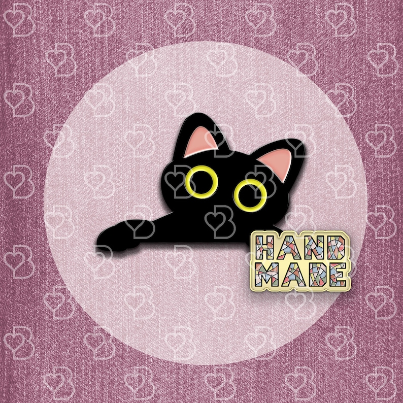 May include: Black cat with yellow eyes peeking out from behind a handmade sign that says "HAND MADE".