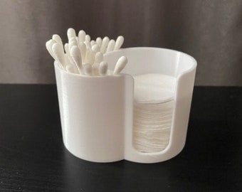 May include: White plastic organizer with two compartments. One compartment holds cotton swabs and the other holds cotton rounds.