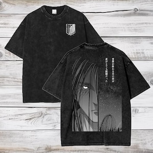 May include: Black t-shirt with a faded look. The front features a white winged symbol. The back features a black and white illustration of a character with the text "世界が終わる日の夜は、君がいて 僕は 頑張れたんだ".