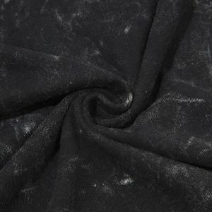 May include: Close-up of black fabric with a distressed, mottled effect. The material is tightly woven, with a slightly textured surface and subtle tonal variations, giving a vintage or worn look. The fabric is gathered, showing folds and shadows.