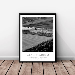 May include: Black and white framed print of CPKC Stadium in Kansas City, Missouri. The image shows the stadium filled with spectators and players on the field. The text "CPKC STADIUM" is printed at the bottom, along with the city and state.