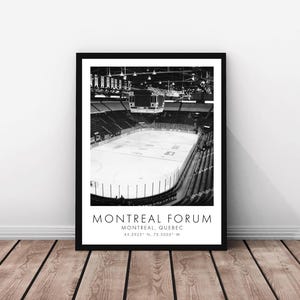 May include: Black and white framed print of the Montreal Forum ice hockey arena. The image shows the empty arena with the ice rink and seating. Text at the bottom reads "MONTREAL FORUM, MONTREAL, QUEBEC" with coordinates.