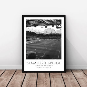 May include: Black and white photograph of Stamford Bridge, a football stadium in London, England. The photo shows the pitch and stands from a high angle. The text "STAMFORD BRIDGE" and "LONDON, ENGLAND" is printed below the image.