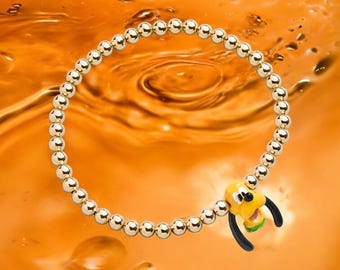 Pulsera elástica de latón bañado en oro de Disney Pluto Pisa con detalles en 3D. Nueva con etiquetas. Producto con licencia oficial de Disney.