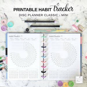 May include: A printable habit tracker for a disc planner classic mini. The open planner features two pages with circular habit tracking charts, monthly calendars, and a central spine with colorful discs. Text includes PRINTABLE HABIT tracker, DISC PLANNER CLASSIC - MINI, and HOLD THAT Thought.