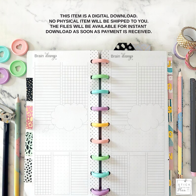 May include: A planner with a dotted spine and colorful disc binding. The planner pages are white with grid and lined sections. The text "Brain Dump" is visible. Decorative pencils, washi tape, and heart-shaped paper clips surround the planner.