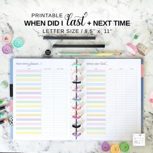 May include: A printable planner with the text "When Did I Last + Next Time" and "Letter Size / 8.5" x 11". The open planner has pastel-colored task sections and is held together with colorful disc binding. Pencils, washi tape, and other stationery items are also visible.