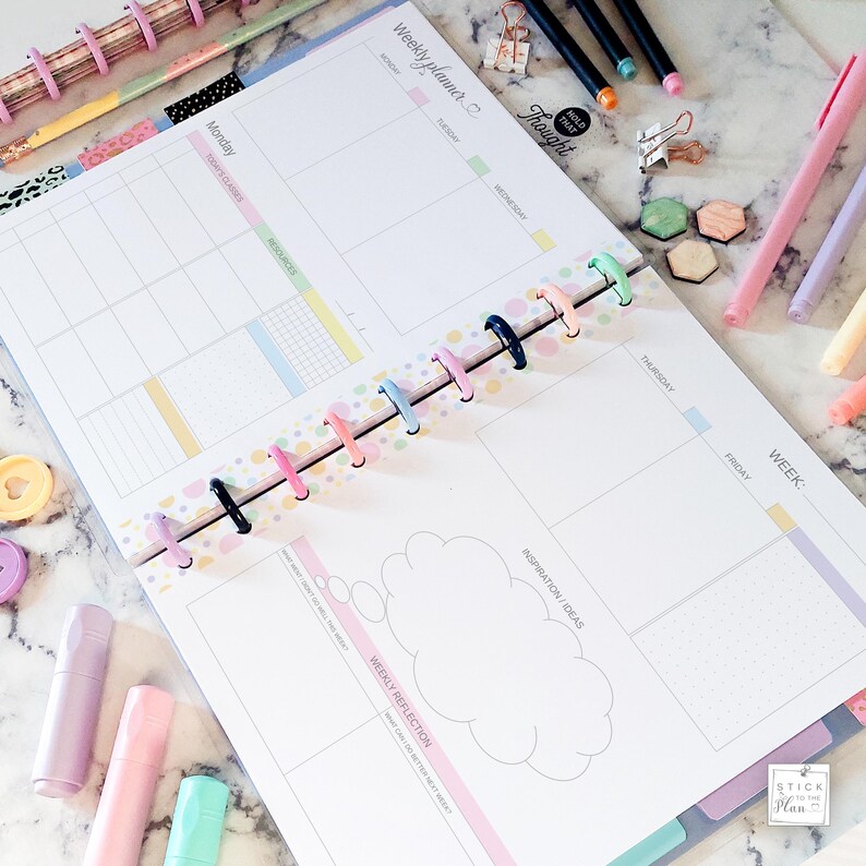 May include: A pastel-colored weekly planner with a spiral binding, open to display the layout. The planner includes sections for each day, a weekly reflection area, and the text "Weekly planner" and "HOLD THAT Thought". Pens and highlighters surround the planner.