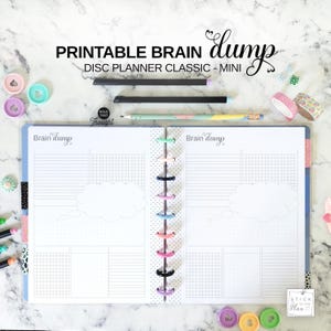May include: An open printable Brain Dump disc planner with lined and grid pages, featuring thought bubble graphics. The planner has a colourful disc binding. The text "PRINTABLE BRAIN dump DISC PLANNER CLASSIC - MINI" is at the top.