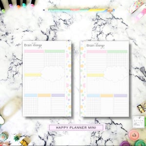 May include: Two identical planner inserts labeled Brain dump at the top. Each page features a pink header, a green grid section, a yellow horizontal bar, a large white cloud shape, a dot grid area, and three bottom sections with grid, dot, and lined layouts.