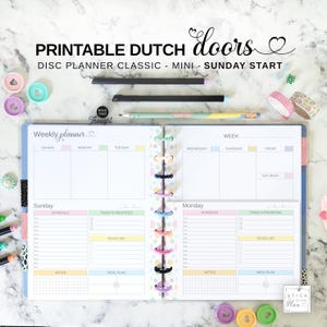 May include: A disc-bound weekly planner with a Sunday start, featuring printable Dutch doors. The open planner displays sections for schedule, priorities, to-do lists, notes, and meal plans. Text includes PRINTABLE DUTCH doors, DISC PLANNER CLASSIC - MINI - SUNDAY START, Weekly planner, Sunday, Monday, and STICK TO THE PLAN.