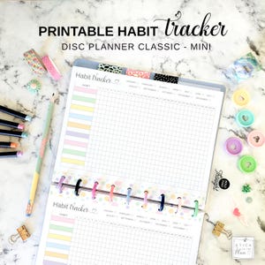 May include: A printable habit tracker for a disc planner classic mini, featuring a grid layout with pastel-colored rows for habits and numbered columns for days. The page includes months from January to December and the text "PRINTABLE HABIT tracker".