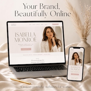 May include: A laptop and a smartphone displaying the Isabella Monroe branding and web design website. The screen shows the text Your Brand, Beautifully Online, Isabella Monroe, and Elevated design for purpose-led women. A gold pen lies nearby.