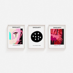 May include: Three framed prints with the word "Singularity" at the top of each. The left print features a pink and blue face with a single teardrop. The middle print features a black circle with nine white faces inside. The right print features a red arm with a hand reaching out. The text below each print is in Korean.