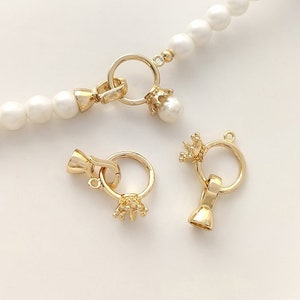 May include: Three gold-toned jewellery clasps with a crown design. The clasps are for necklaces or bracelets.