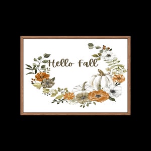 May include: A white framed print with a watercolor illustration of a floral wreath with pumpkins and the text "Hello Fall".