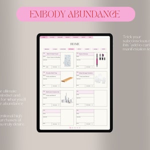 May include: A digital tablet shows a mock-up e-commerce site with product images and descriptions. The text "EMBODY ABUNDANCE" is at the top. The screen displays items like towels, bath trays, and storage canisters. The tablet is on a neutral background.