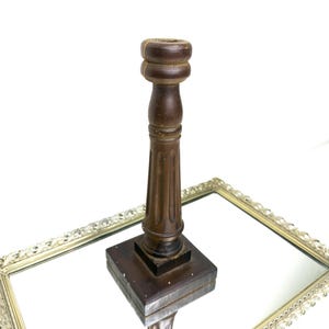 Classic dark wooden candlestick holder with a turned column and a square base, vintage wood candle holder