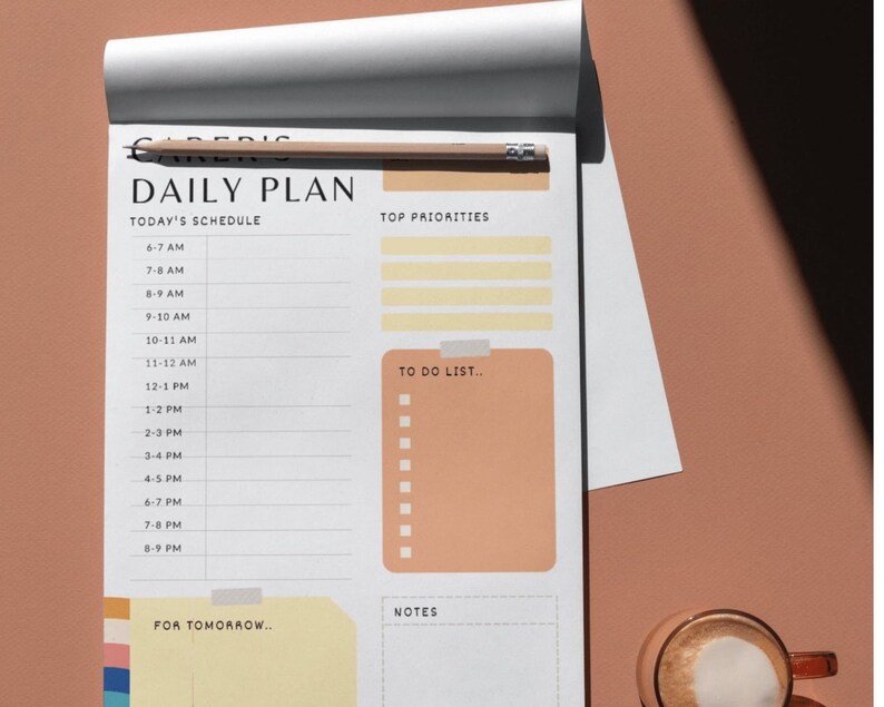 May include: A daily planner with a white background and black text. The planner has sections for today's schedule, top priorities, to do list, notes, and for tomorrow. The planner is open to a page with the time slots from 6:00 AM to 8:00 PM.