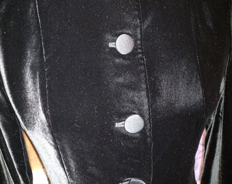 May include: A black velvet jacket with a Peter Pan collar and five black buttons.