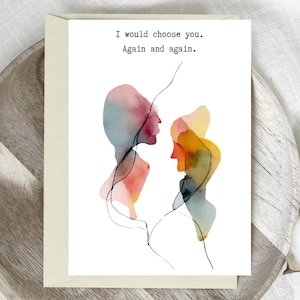 May include: Greeting card with watercolor silhouettes in shades of red, yellow, and blue. The card features the text "I would choose you. Again and again." on a white background, with a cream-colored envelope.