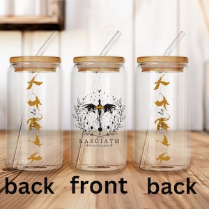 May include: Three glass jars with bamboo lids and straws. The middle jar has a black and gold design with the text "BASGIATH WAR COLLEGE" and a dragon. The other two jars have a gold dragon design and the text "Fly or die".